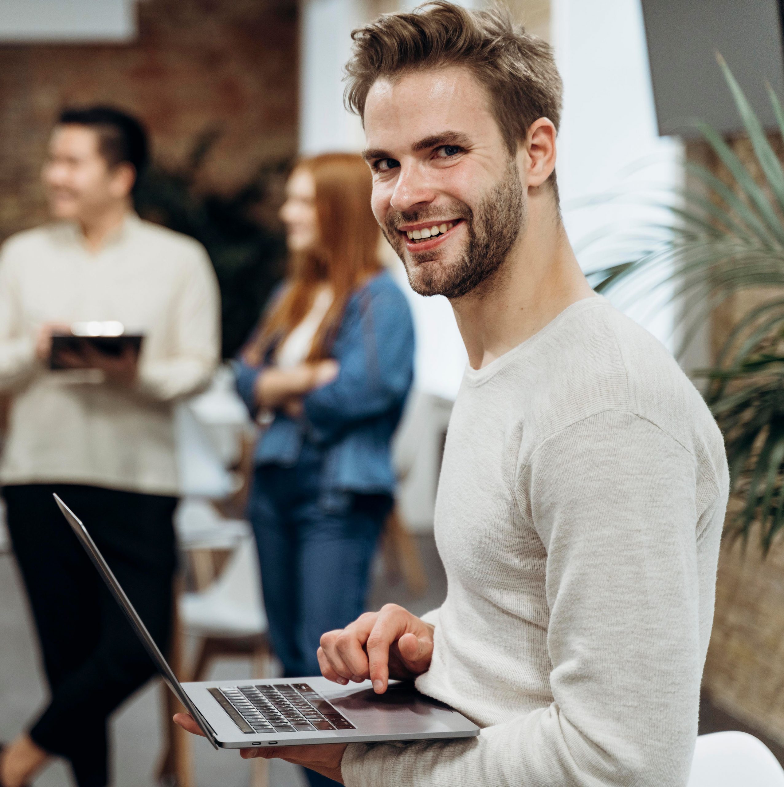 2smiley-man-working-laptop-while-standing 2smiley-man-working-laptop-while-standing